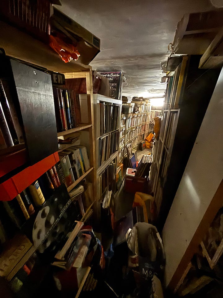 The basement is floor to ceiling records and books that have yet to make their way upstairs