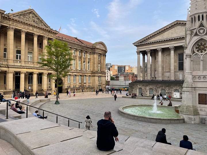 Various pictures of transport in the UK's second city. They include trams, excellent public spaces, hire bikes, Birmingham New Street Station, and Black Sabbath