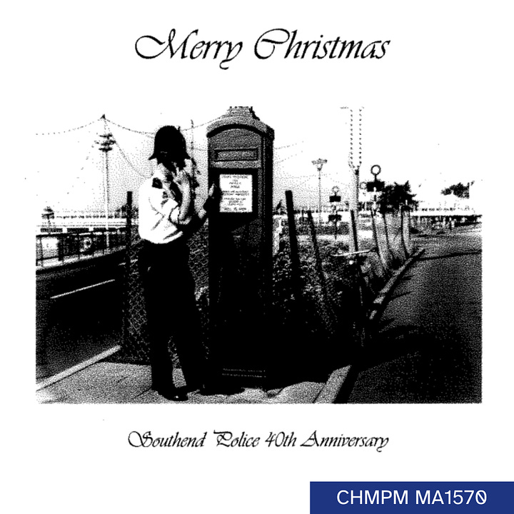 A black and white image of a police officer standing at a police phone box on Southend sea front. Text reads Merry Christmas, Southend Police 40th Anniversary. Inside is written Seasons greetings from all the Officers and staff Southend Division Essex Police.