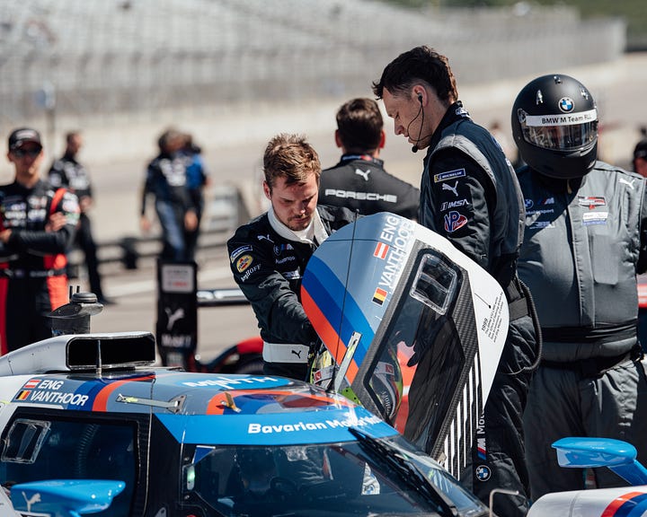 BMW M Team RLL drivers discuss strategy before the IMSA Monterey round at Laguna Seca in May 2025. Photos by Walter Fulbright.