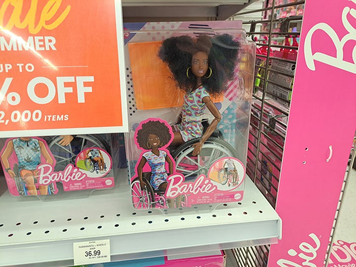 Images of Wheelchair Barbie and Ken on a store shelf