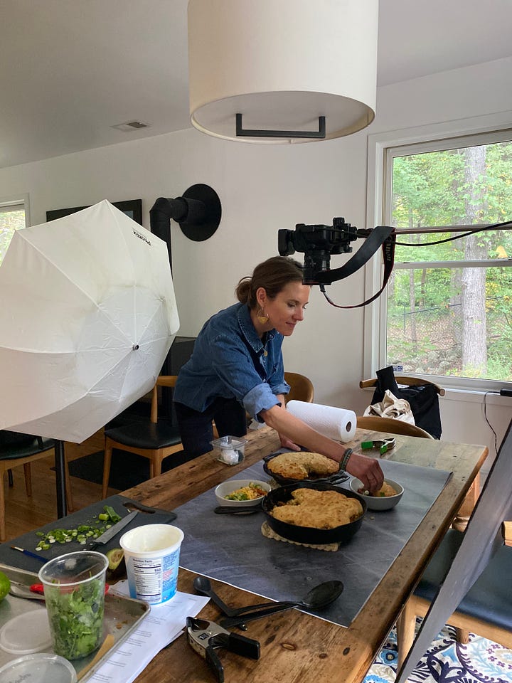 Photo shoot taking place in a kitchen with lots of food on the counter tops.