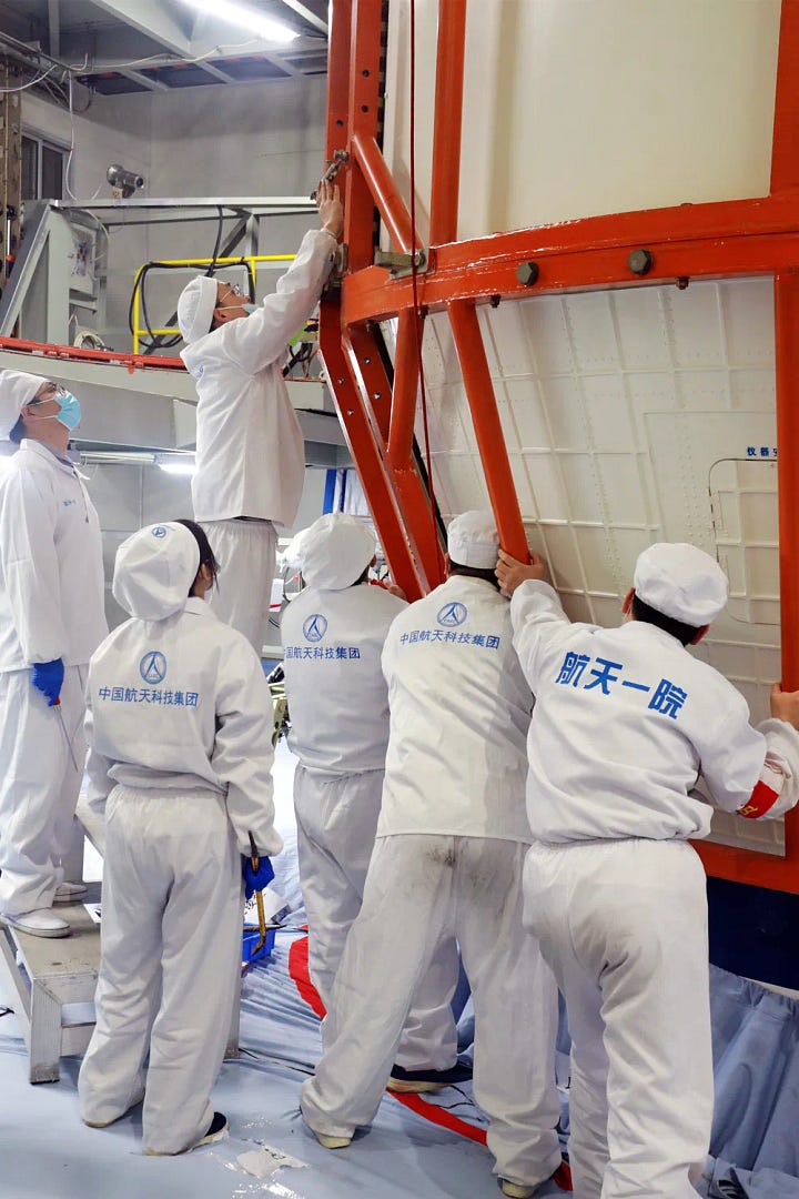 Hardware for the Long March 3B/E heading to the launch pad and being prepared for launch.