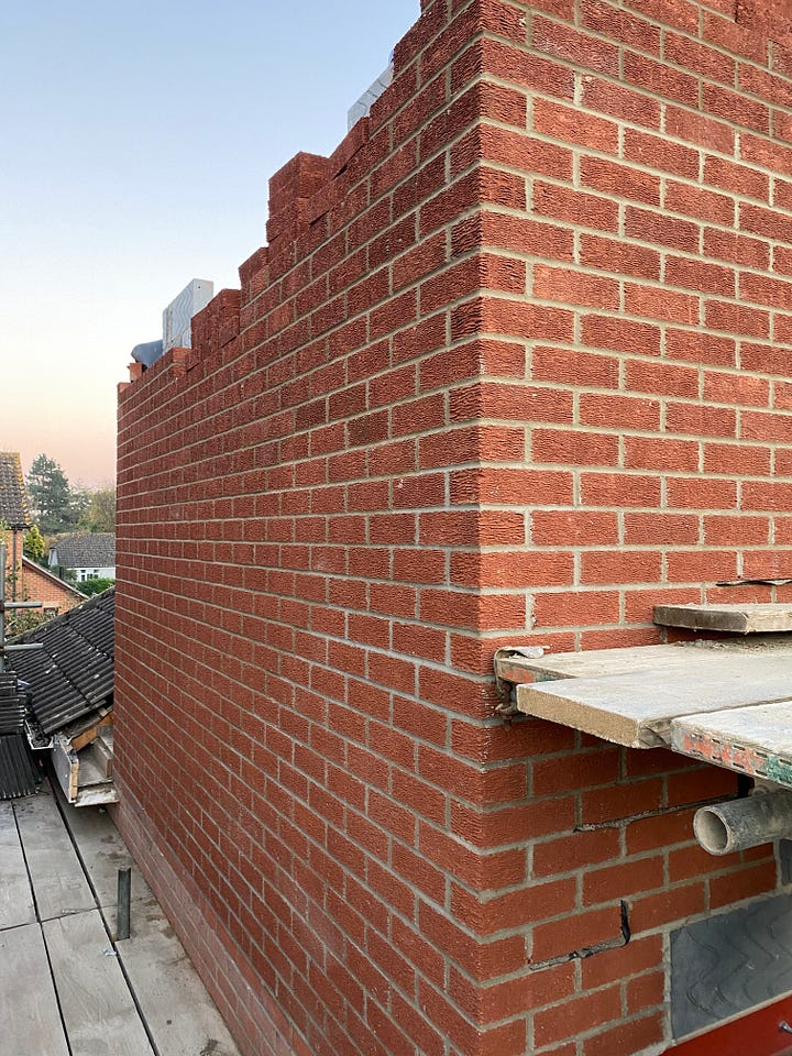 red bricked wall with window opening