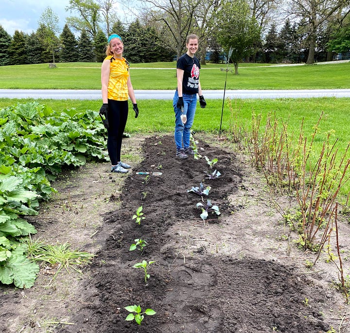 Author's young adult daughters helping her father plant a garden.