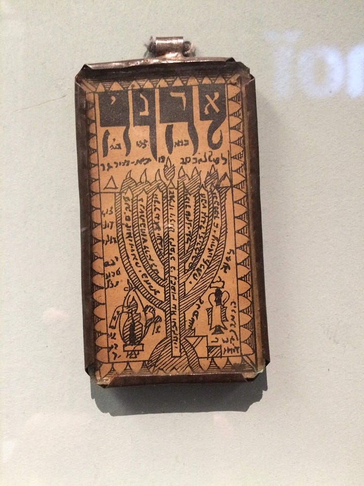 Amulets with Hebrew word “Adonai” written inside the Hebrew letters YHVH. Photo by Ketzirah at Musée d'Art et d'Histoire du Judaïsme in Paris, France (2015). 