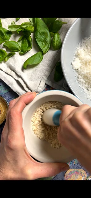 Pesto Genovese pine nuts italian cheese basil smashed together with a mortar pestle