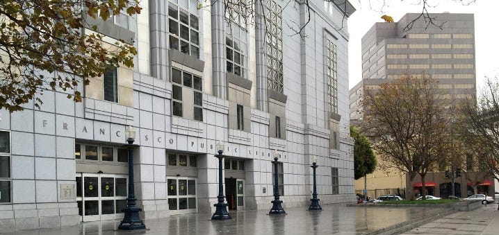 The first photo shows the gray barren plaza in front of the San Francisco Public Library. The second photo shows the same plaza filled with bright yellow columns containing exhibit interactives.