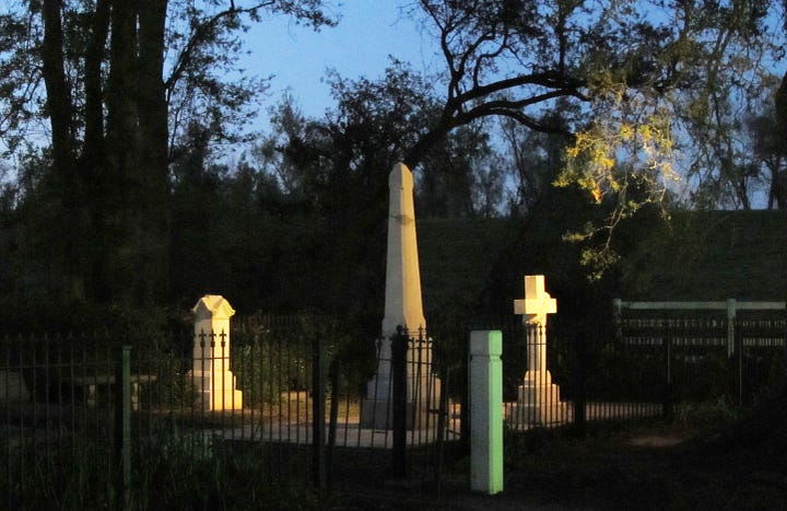 The Nottoway Plantation House with a full moon and the family cemetery.
