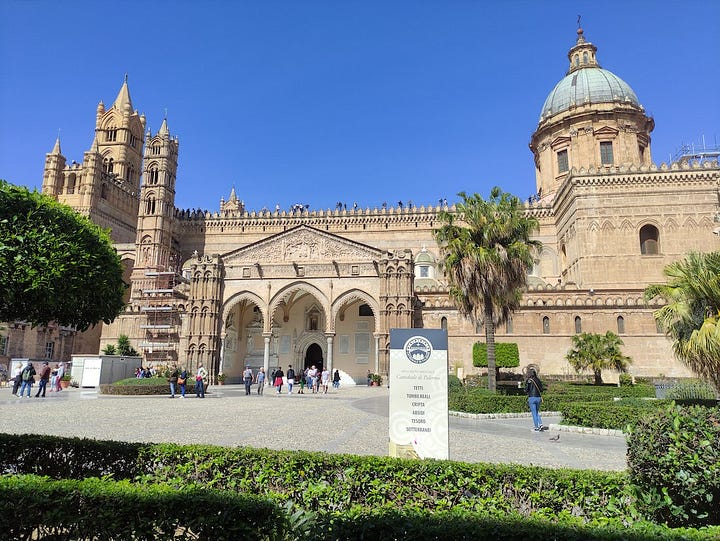 A large weather vane the size of a car and ornate buildings from Palermo