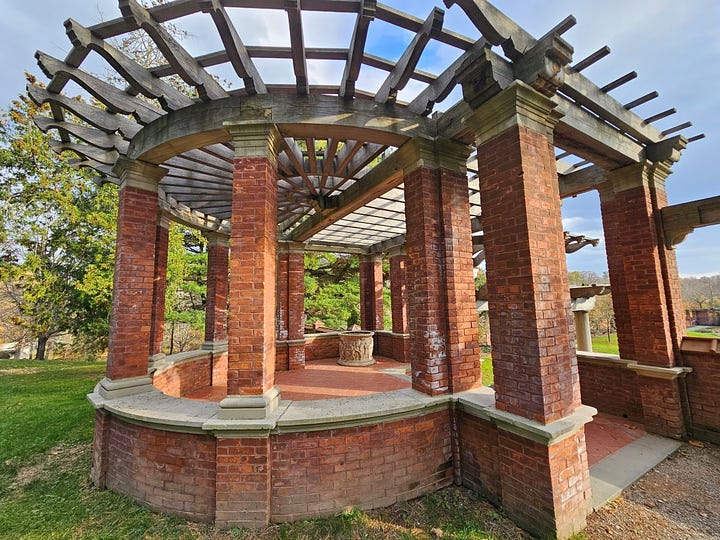 Looking at the Hudson River from between two pillars and the brick gazebo in the garden.
