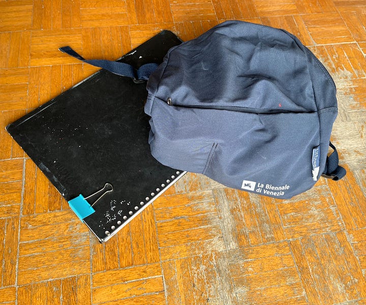 Picture of a small rucksack, paper and boards, and various art materials