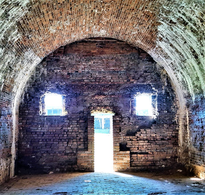 Inside Fort Morgan in Alabama with arched entrance ways to the rooms.