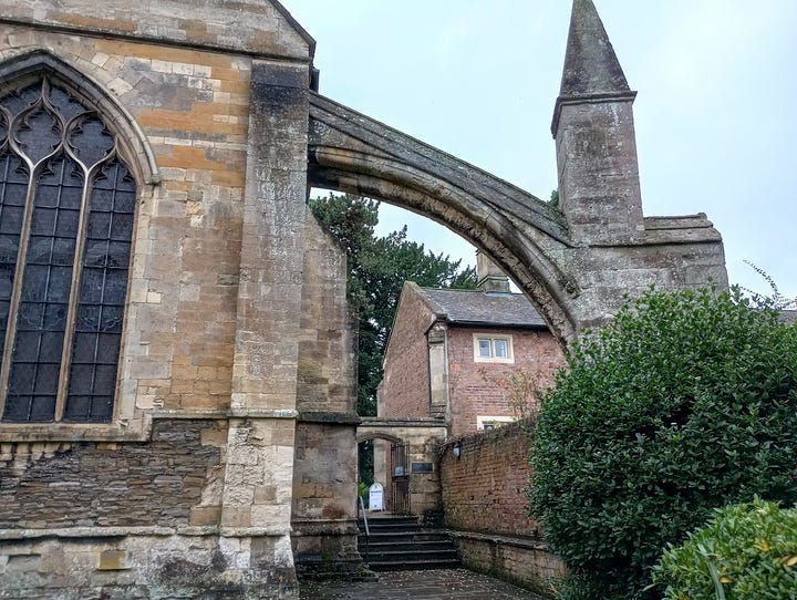 Two external towers with arches attached to a huge stone building