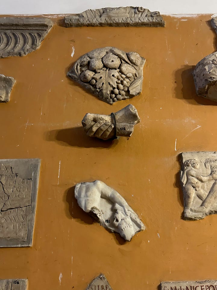 Inside the sacristy of San Pancrazio. 1, pieces of name plates from the catacombs. 2, sculptural fragments. 3, more sculptural fragments. 4, Le Bombe de Napoleon