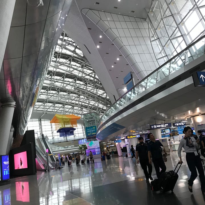 The hyper-modern train station at Incheon Airport, South-Korea, and the reclining author at the Dongdaemun Design Plaza, Seoul.