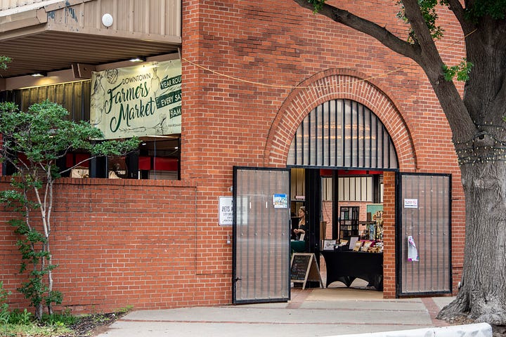 Vendors and red brick and pretty lights at The Moon Market