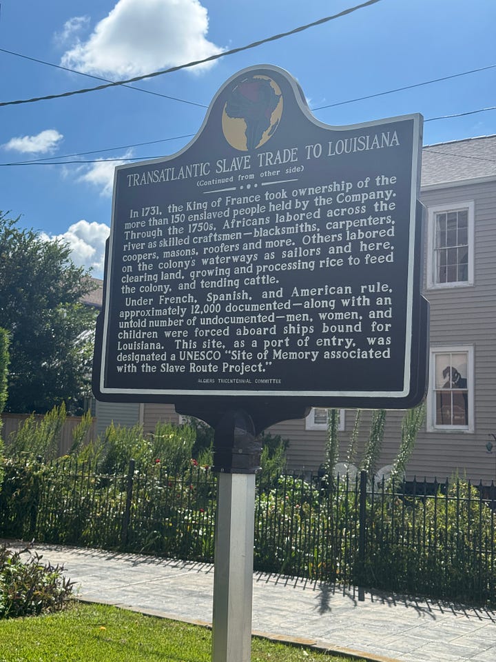 Signs in front of a court house in Algiers, New Orleans, Louisiana. The sign explains that majority of enslaved Africans in Louisiana arrived through this port.