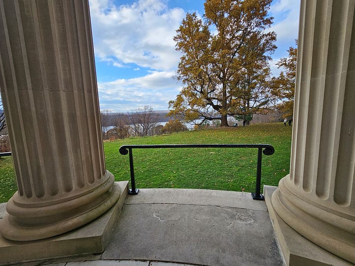 Looking at the Hudson River from between two pillars and the brick gazebo in the garden.