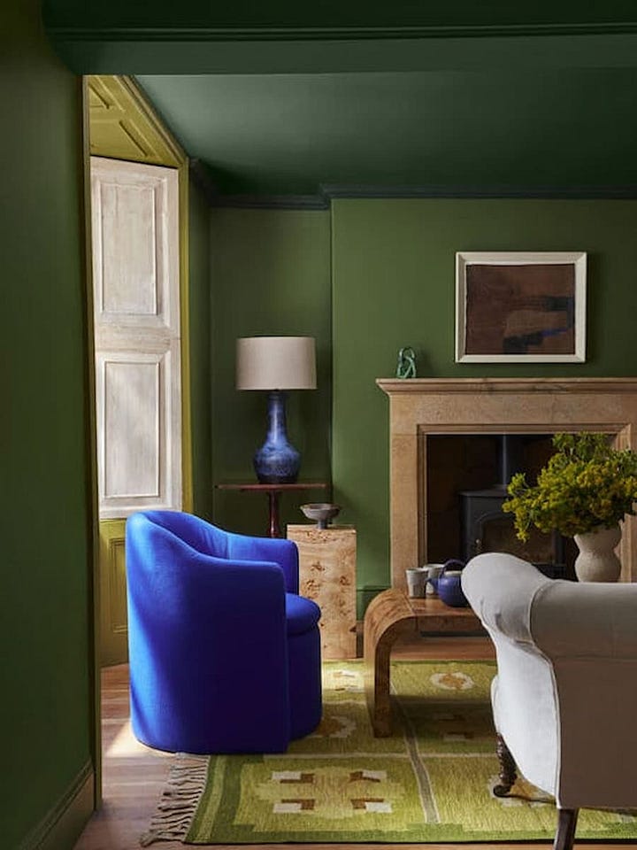 office space painted completely in shades of blue and living room painted in shades of green