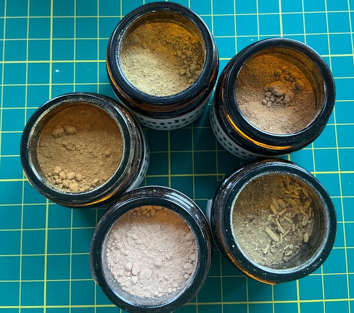 A circle of five jars containing powdered barks and capsules