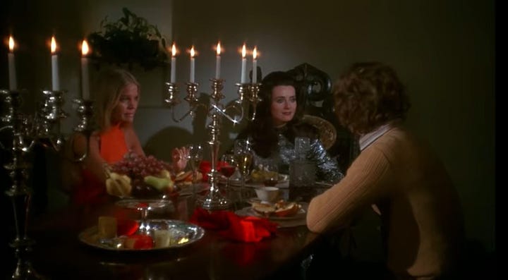 left: A still from Daughters of Darkness where a blonde in a silver sequin gown sits with a man in a red robe to her left and his blonde wife sits to her left. They are at a table with silver servwear and tall candlesticks. On the right, a brown-haired woman in a silver sequined dress sits between a blond woman (to her right) and her husband (to her left), they all sit at a dinner table with silver platters and tall candlesticks.