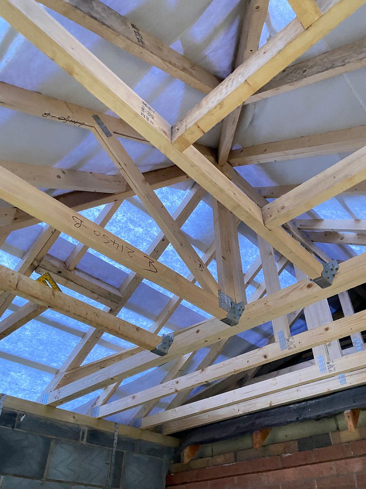 wooden beams positioned for the ceiling