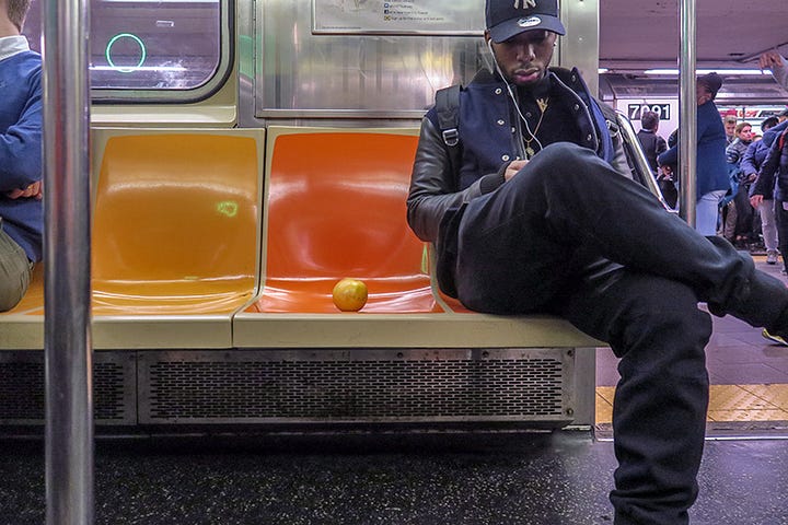 photo of a grapefruit on NYC subway seat. photo by Steve Butcher