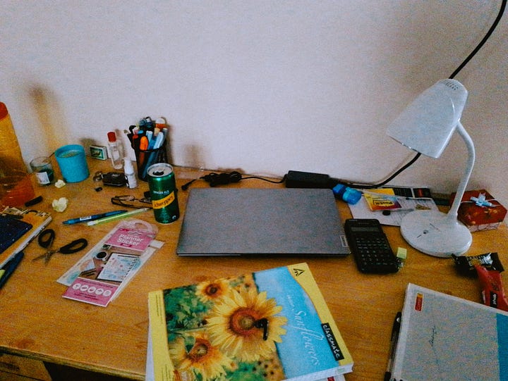 images of a desk with a lamp, a laptop and several other stationery items