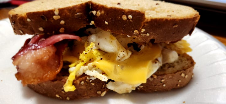 pictured are different shots of a bacon, egg, and cheese sandwich on multigrain bread.