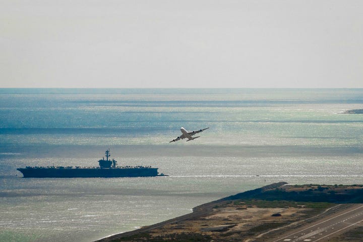 In-port naval open house images including a press conference. One image of the USS Carl Vinson steaming out of Pearl Harbor as a passanger jet takes of at HNL.