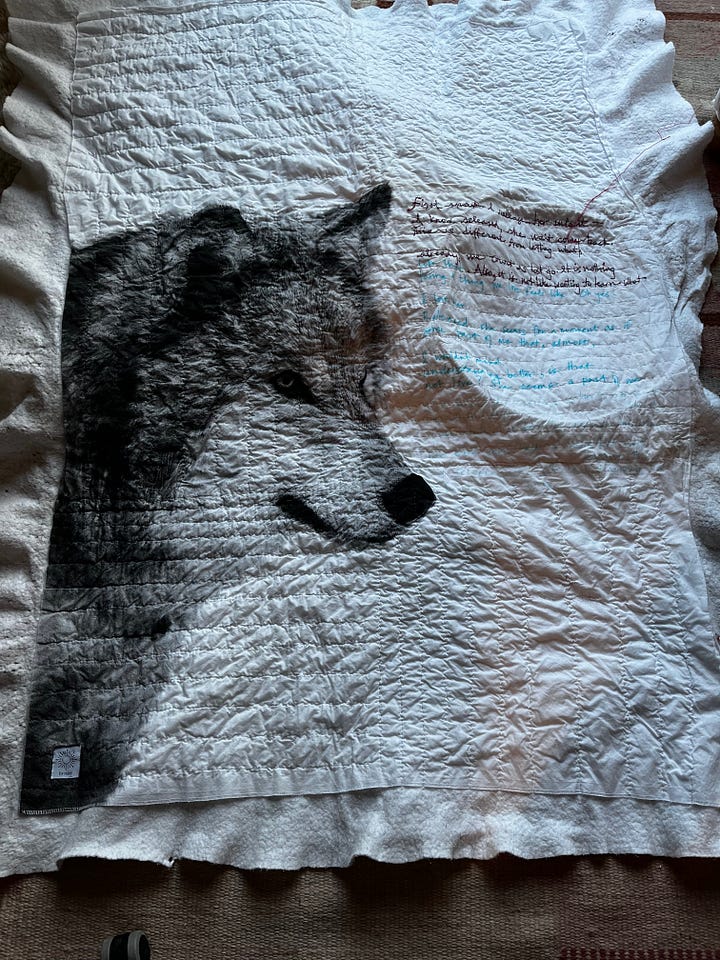images of quilt made of wolf image, with back a number of maps of cities