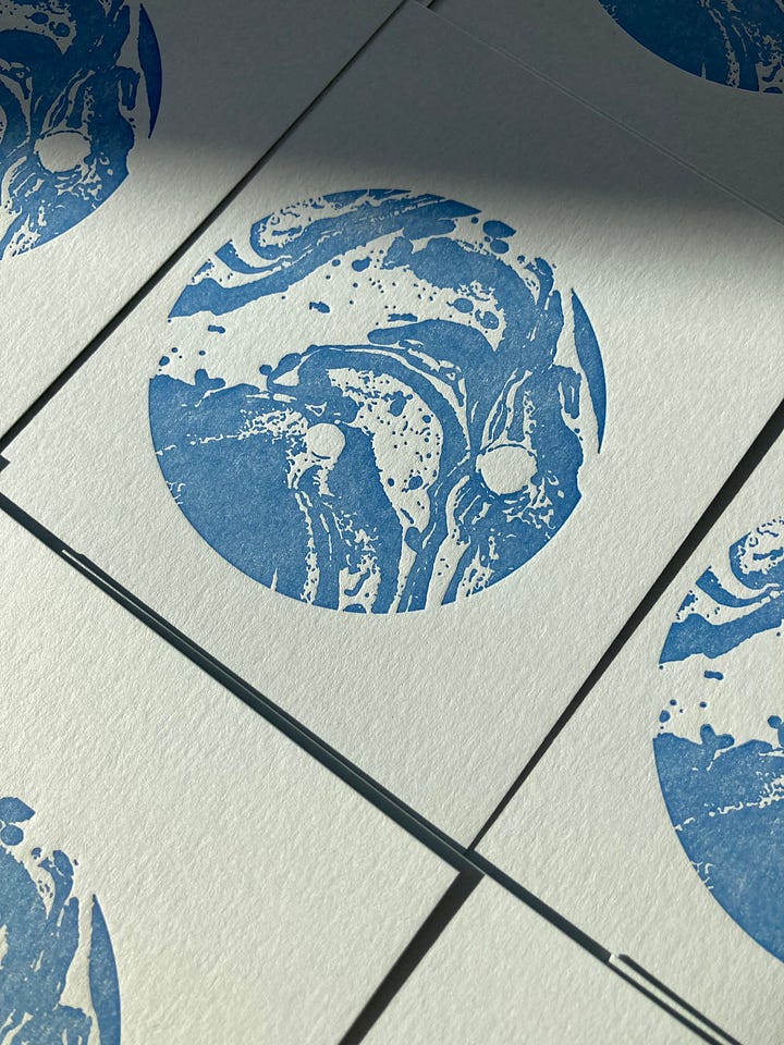 the image on the left shows a blue moon on white paper, letterpress printed. The image on the right is of a slice of cake illustration with the words 2025 illustrated calendar, a collaboration between Molly Reeder and Anna Thompson