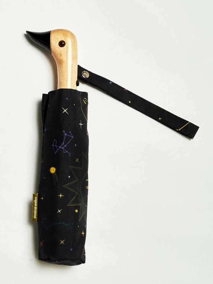 Black umbrella with Halloween zodiac symbols in white, featuring Original Duckhead’s signature duck-head handle. Made from recycled materials, perfect for eco-conscious, spooky-season style