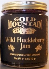 Huckleberry jam in three labels. Huckleberry syrup in Gallone bottles.