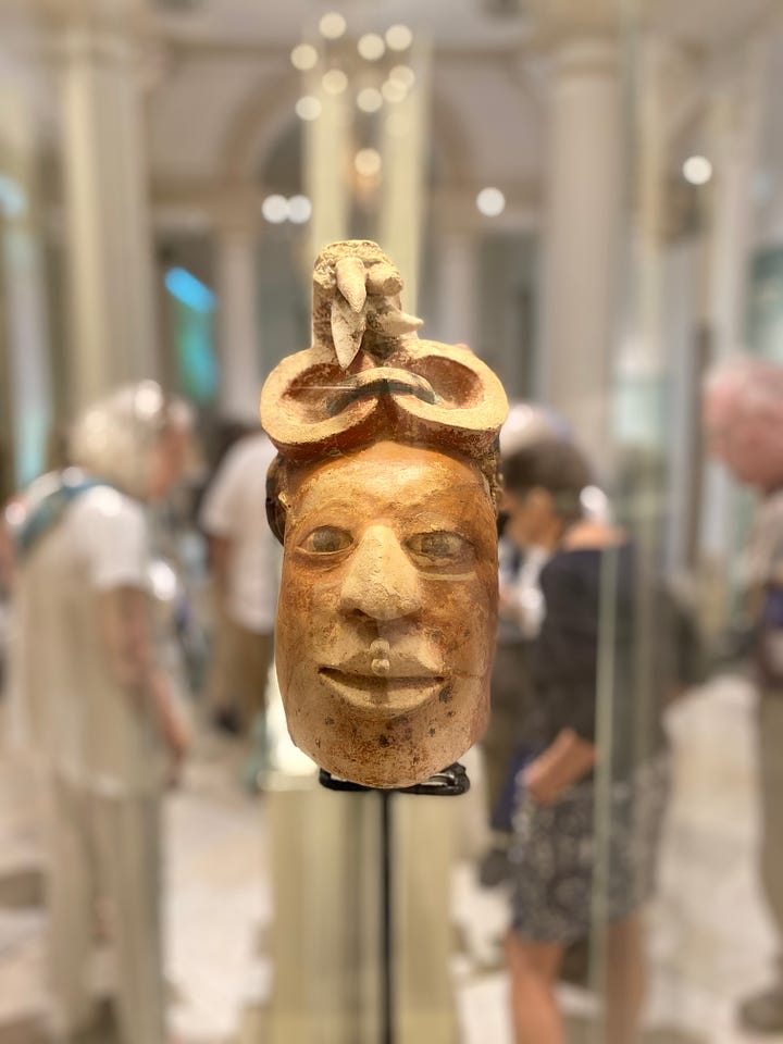 Ancient Mayan artifacts at the Museo Regional de Yucatán, Mérida. Clockwise from top left: A mural from Ek Balam. Statue of a female ruler, with our guide Alfonso. A cylinder vase. Man's head with headdress, Ek Balam.