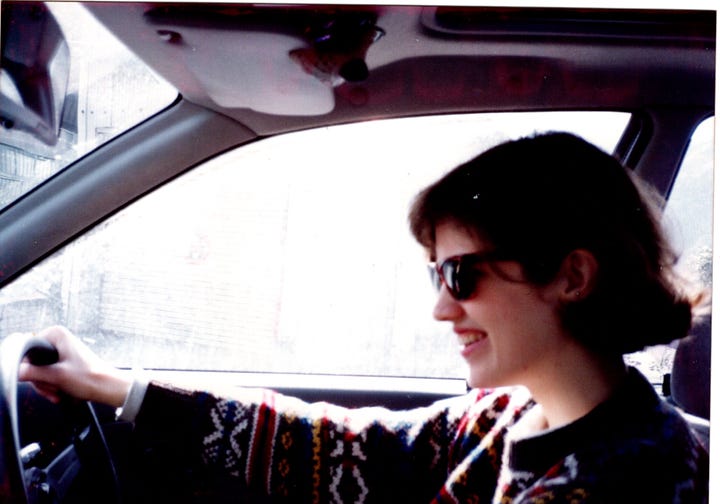 An image of me, smiling and young, driving a car with its steering wheel on the righthand side; and another image of me standing in front of a small, white hatchback at sunset. 