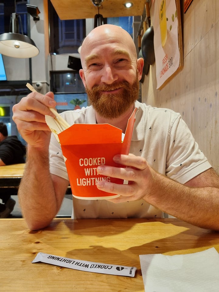 Photo 1: Aisling eating apple pie. Photo 2: Dave eating cheese and crackers. Photo 3: Dave grinning and eating from a red box with the words "cooked with lightning". Photo 4: Aisling grinning, holding a tray of chips covered in truffle mayo. 