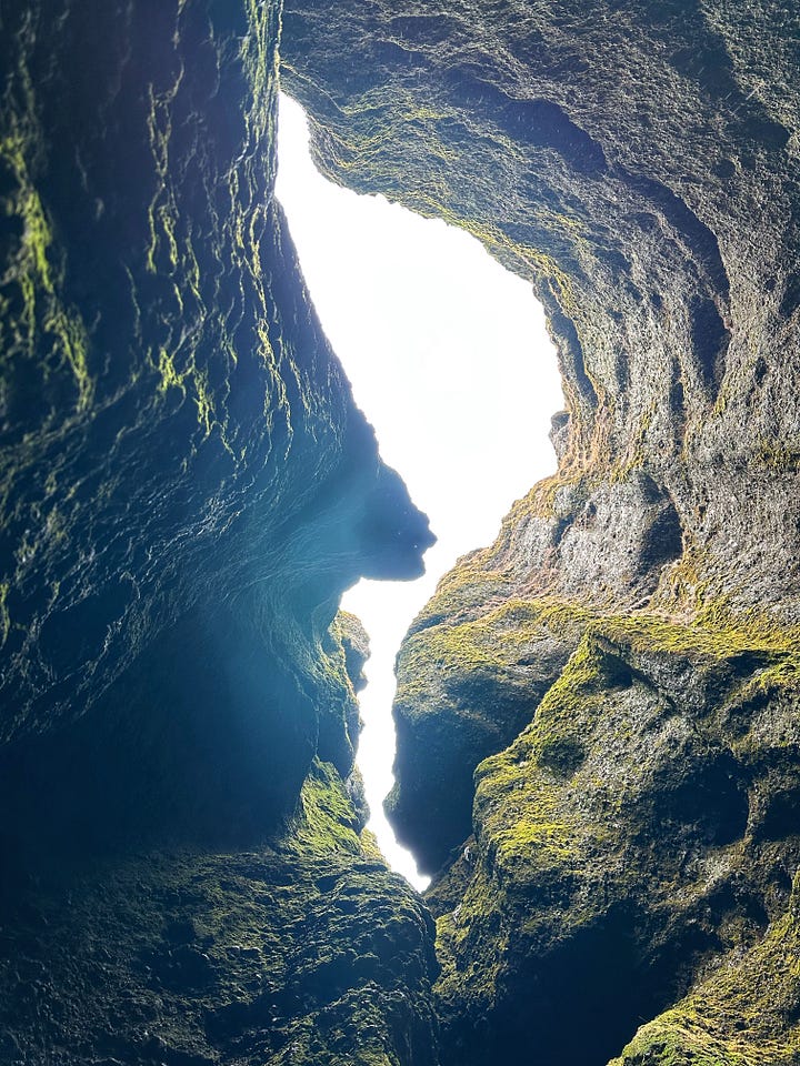 Four images from Rauðfeldsgjá Gorge - clockwise from top left. Ryan in brown pants with a green down jacket standing on rocks ready to enter the second, smaller opening inside the gorge, a close up of the green moss walls and large icicles, the layers of green, gold, black and rusty red color to in the hills next to the gorge, looking up from the streambed inside to the curving opening to the sky above.