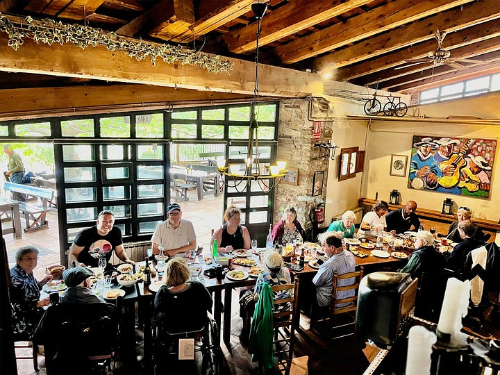 Large paella served to group in historic restaurant.