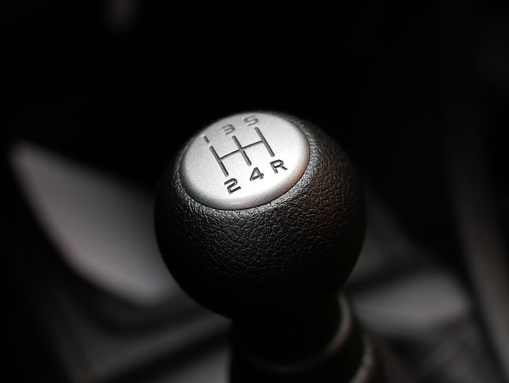 the gear stick in an automatic car and a manual car to show the difference