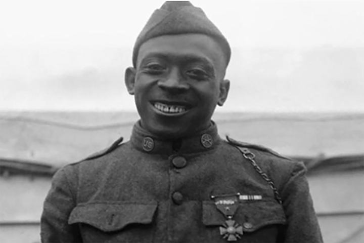 Black army set in uniform, brick sign at Fort Johnson