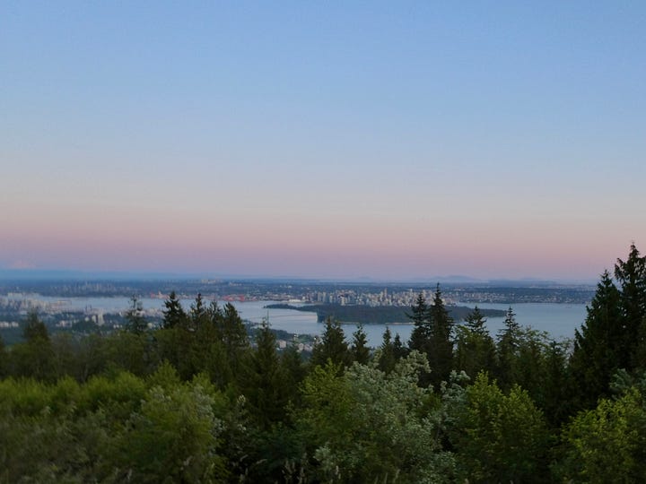 Left: trees in foreground and sea and Vancouver in background. Right: Girl looking through binoculars.