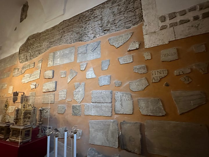 Inside the sacristy of San Pancrazio. 1, pieces of name plates from the catacombs. 2, sculptural fragments. 3, more sculptural fragments. 4, Le Bombe de Napoleon