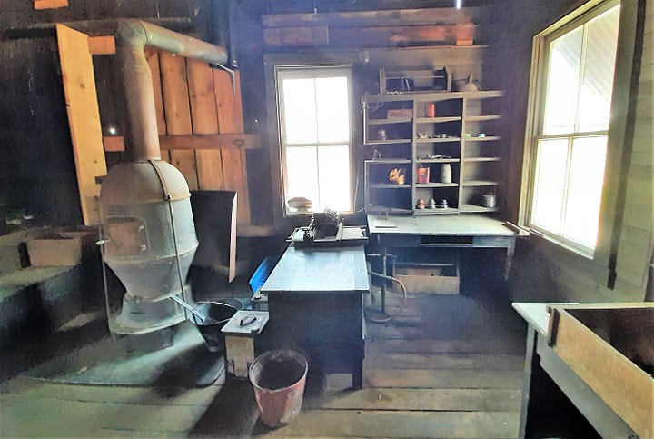 an old stove and desk with wooden floors inside old building.