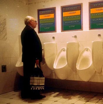 Left A man at a urinal looking at wall-mounted posters of the color-coded national terror-alert level. Right: People covering their ears on the streets of New York City because of noise.