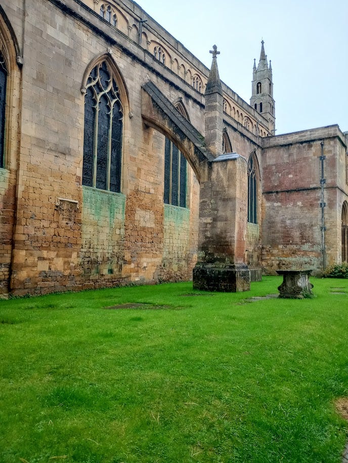 Two external towers with arches attached to a huge stone building