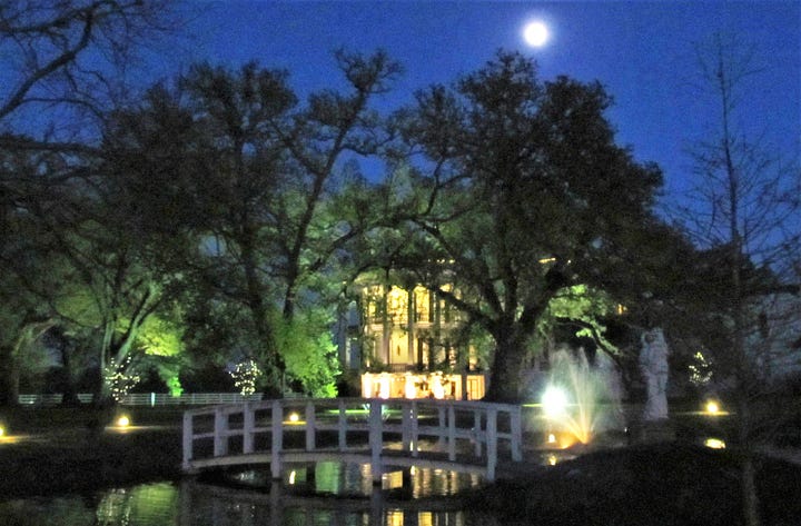 The Nottoway Plantation House with a full moon and the family cemetery.