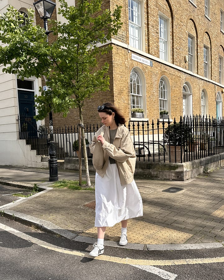 Lucy Moon wears beige onitsuka tiger sneakers, oversized vintage trench coat and suede bag.