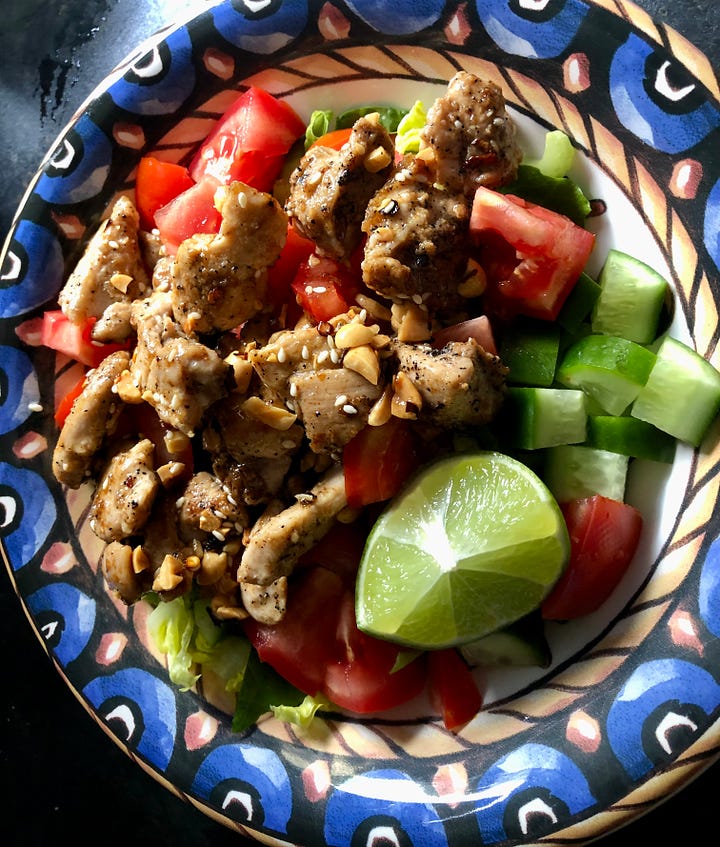 A small saucepan with peanuts and oil, plus a chicken salad